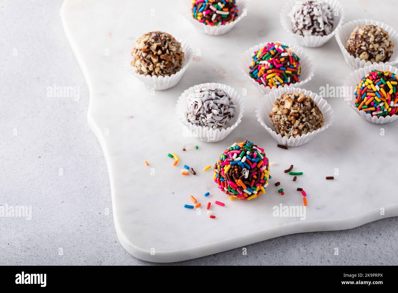 Homemade chocolate truffles covered with sprinkles and nuts Stock Photo
