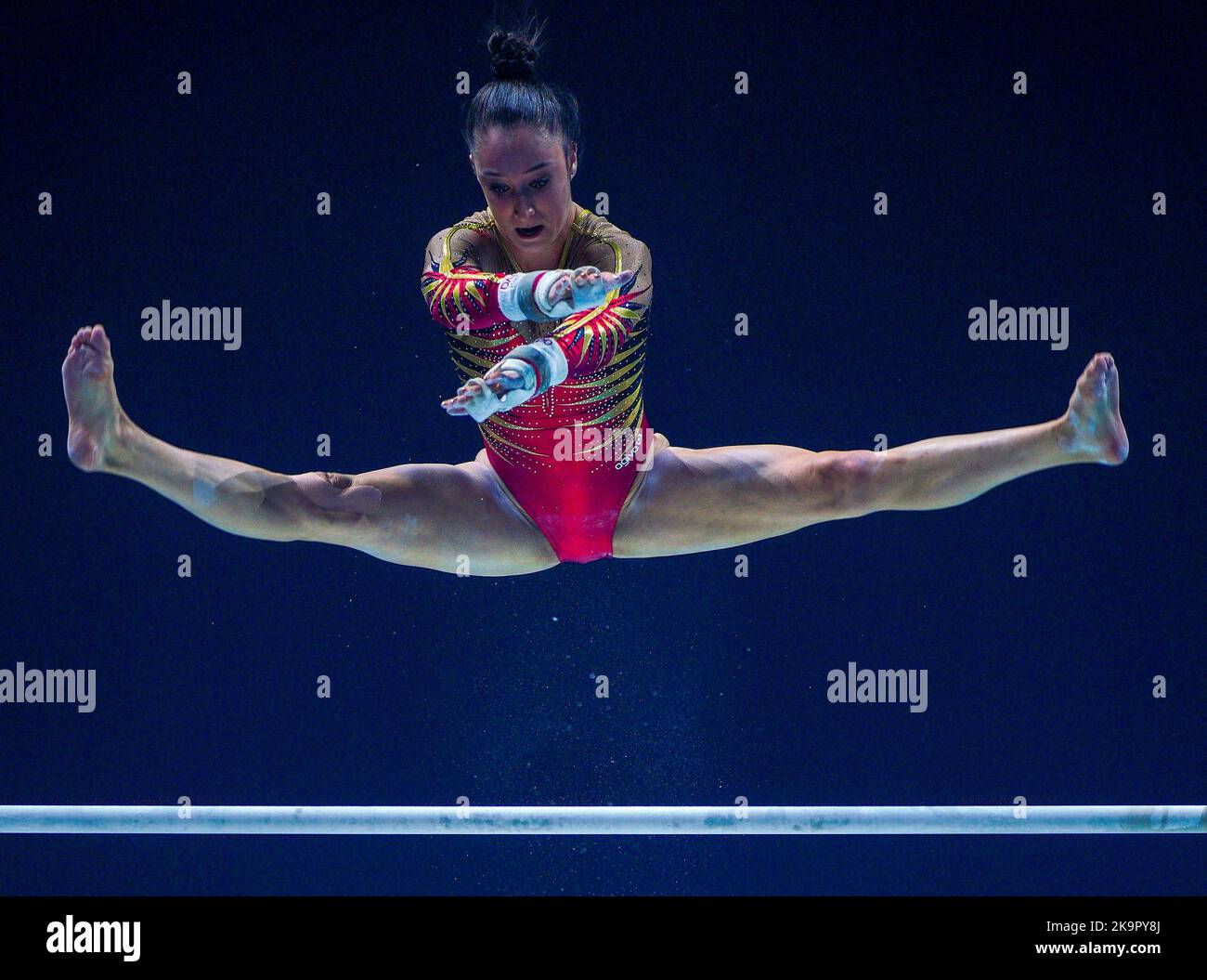 Belgium's Nina Derwael competes on the asymmetrical bars during day one