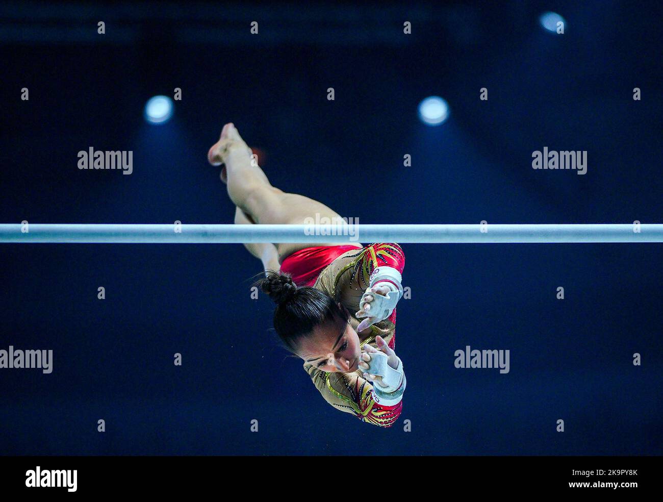 Belgium's Nina Derwael competes on the asymmetrical bars during day one