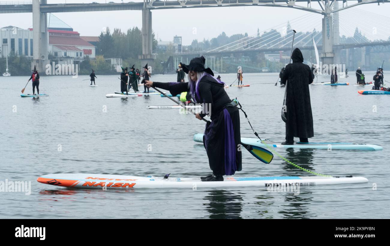 A coven of witches on Stand Up Paddle boards celebrate Halloween in