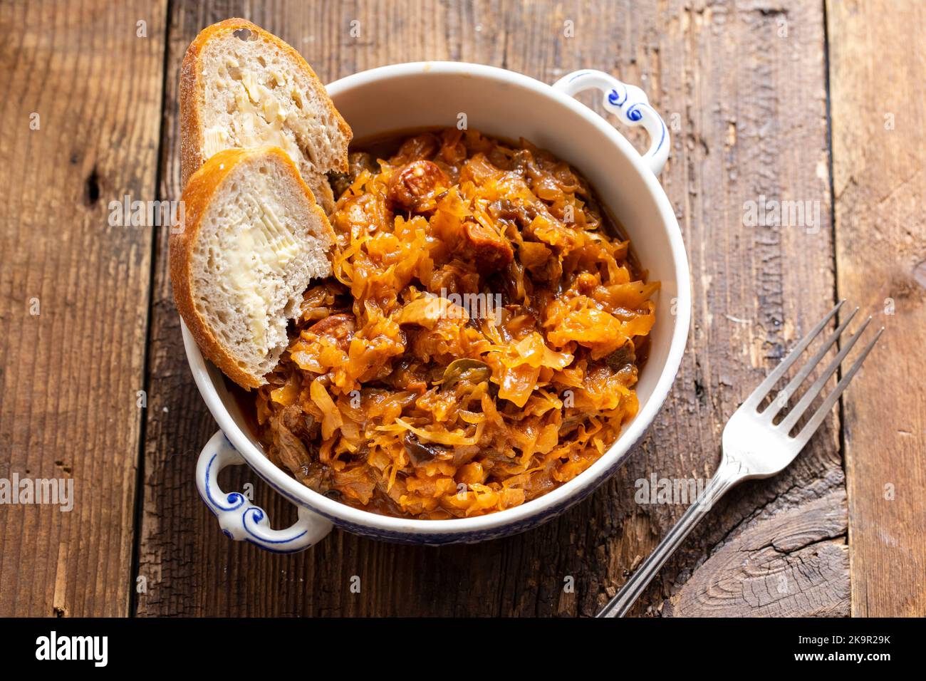 Traditional polish dish of bigos, cabbage with meat, mushrooms and prunes Stock Photo