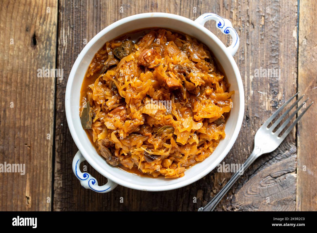 Traditional polish dish of bigos, cabbage with meat, mushrooms and prunes Stock Photo