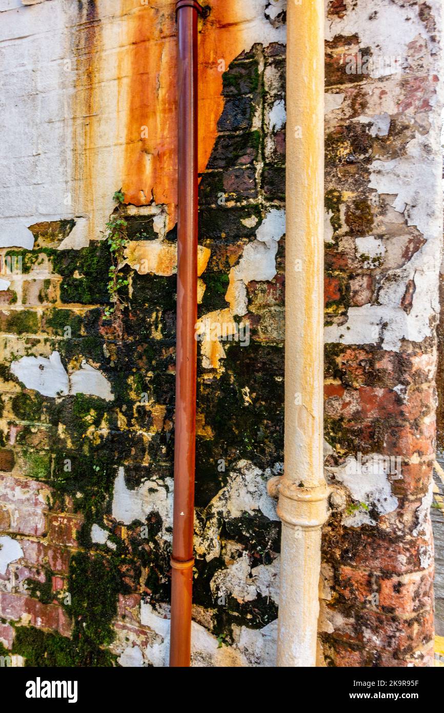 A weathered and worn section of wall with flaking paint and render i need of repair. Stock Photo