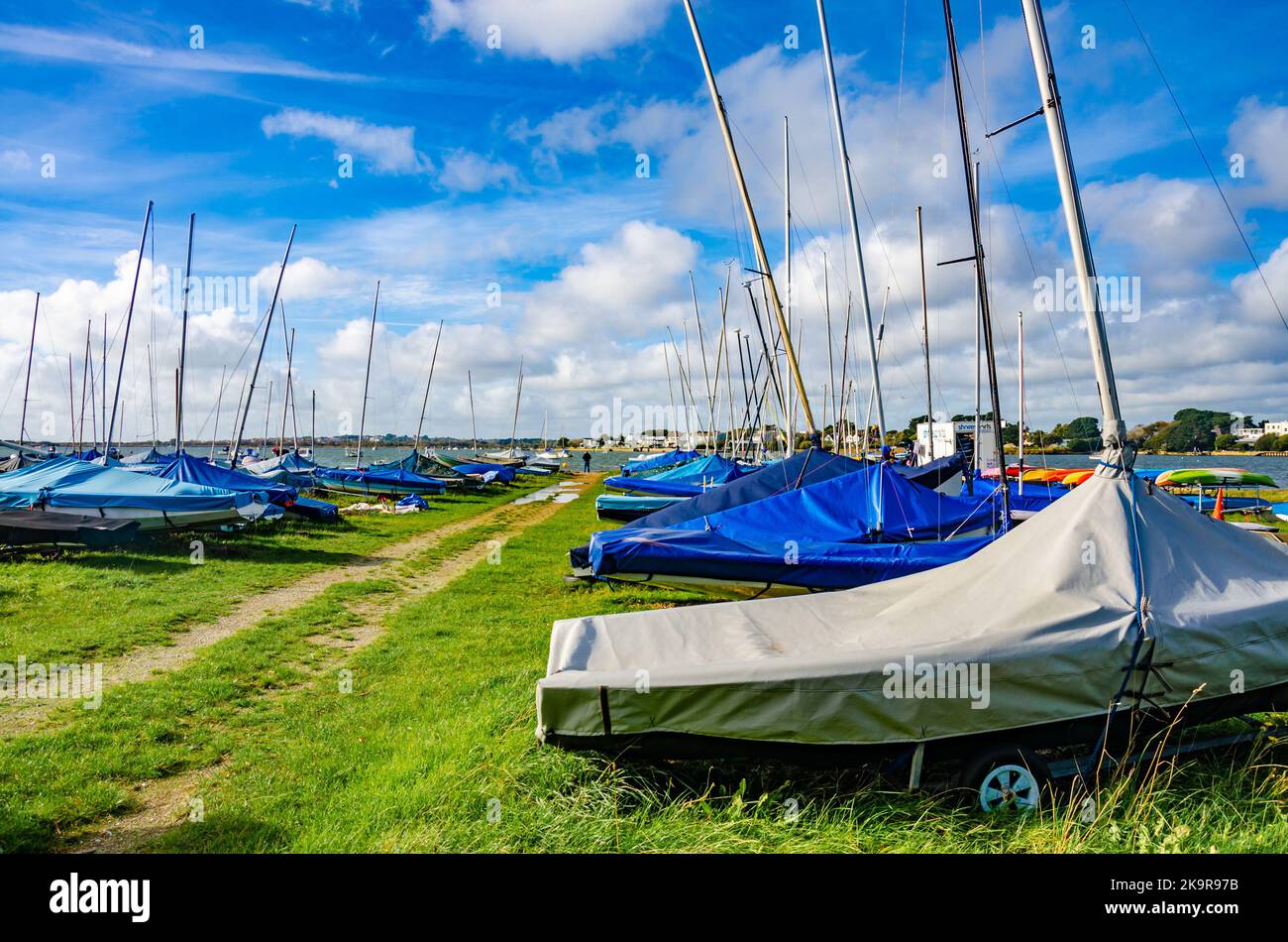 Sailing dinghies stored on trailers in a field at Mudeford near