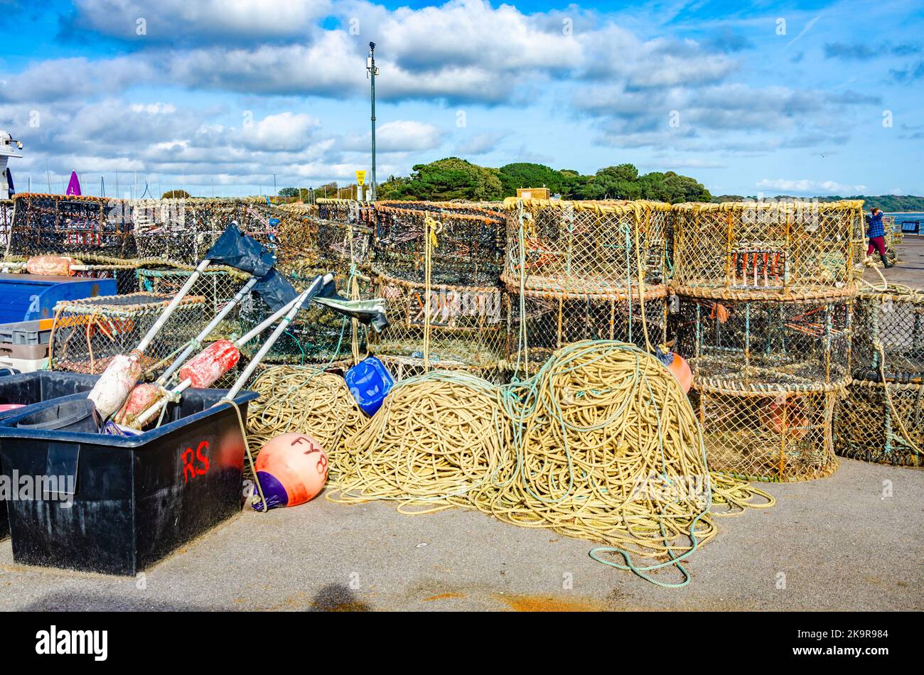 Crab pots piled up on the quayside at Mudeford near Christchurch in Dorst, UK Stock Photo