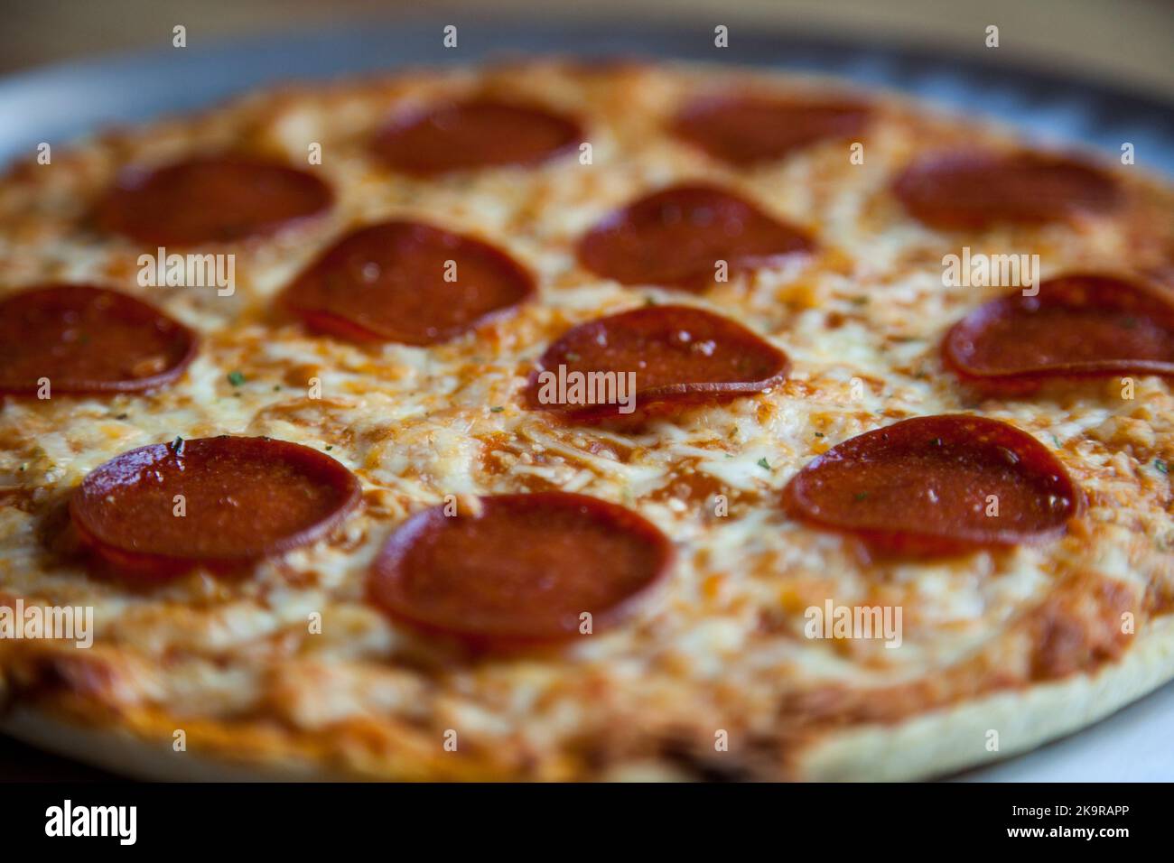 Baked pepperoni and cheese thin crust pizza Stock Photo Alamy