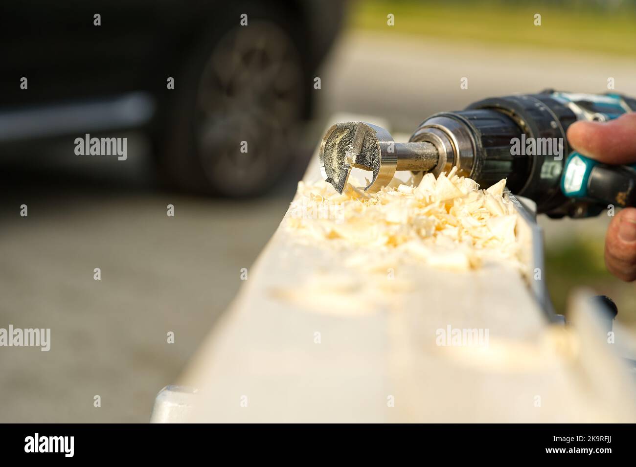 Drilling a hole in a wooden beam with a drill Stock Photo Alamy