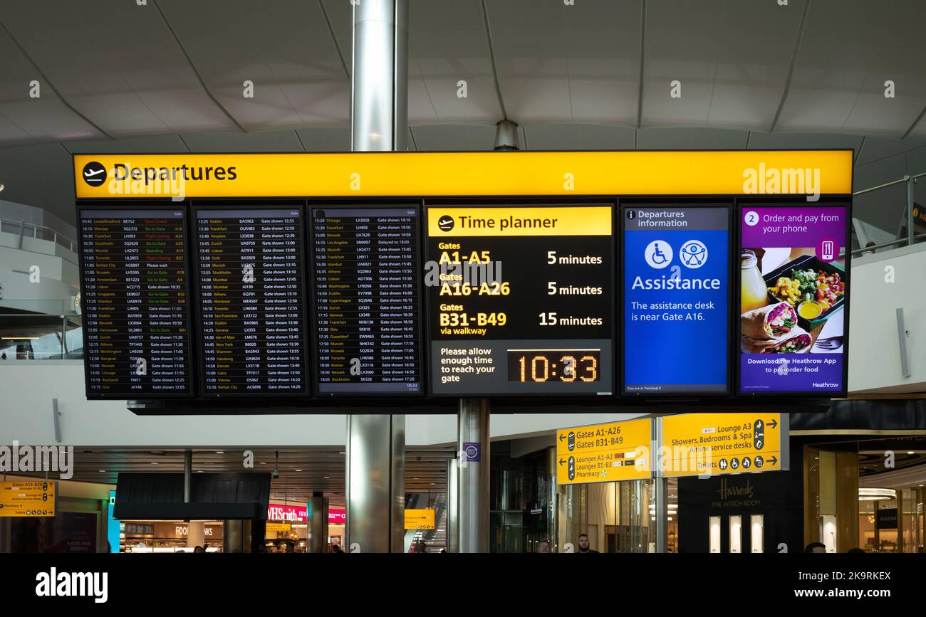 An illuminated information board showing flight departures and information at Terminal 2, London Heathrow Airport, UK. Stock Photo