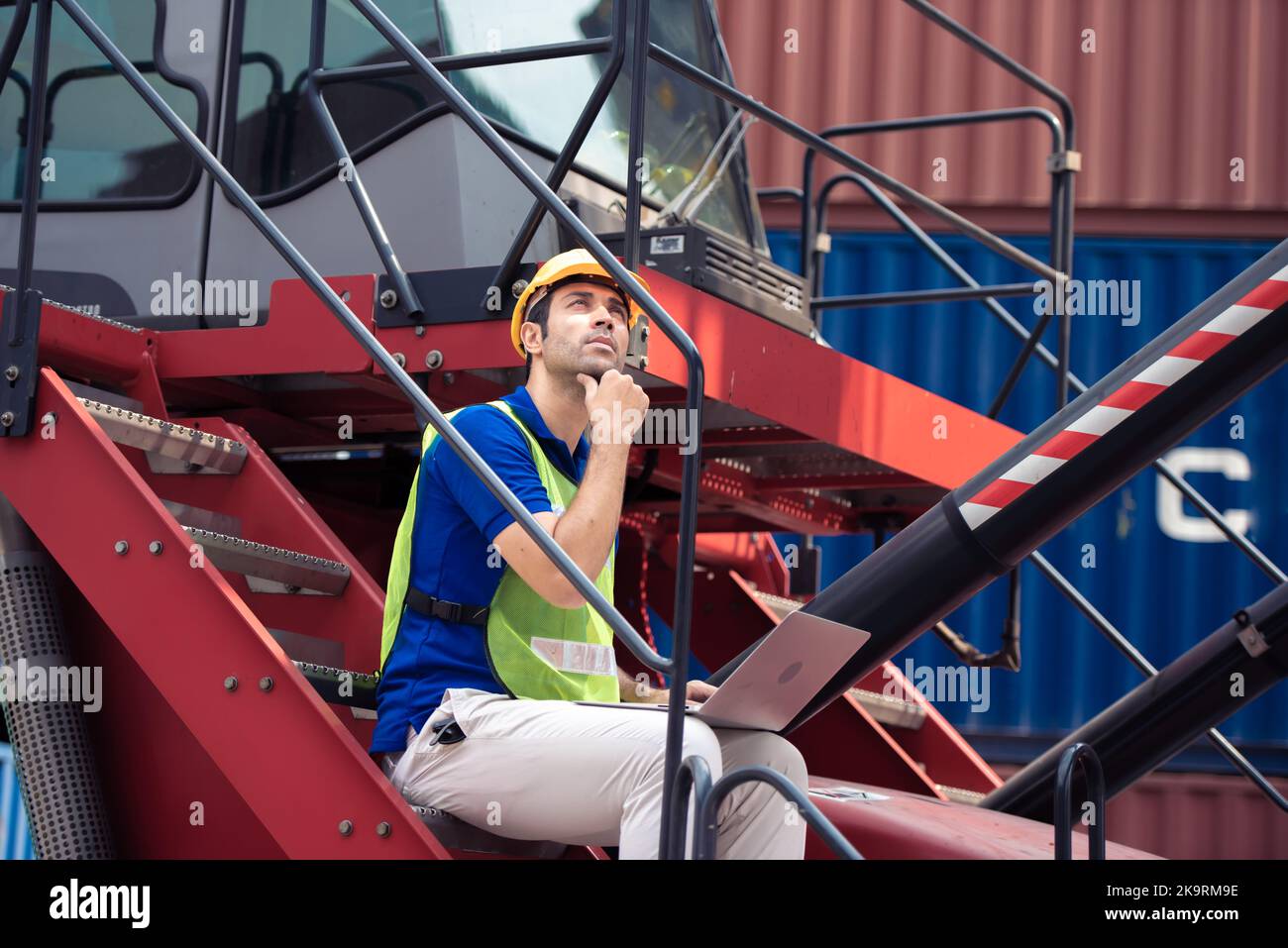 Young man working with computer at logistic import and export terminal ...