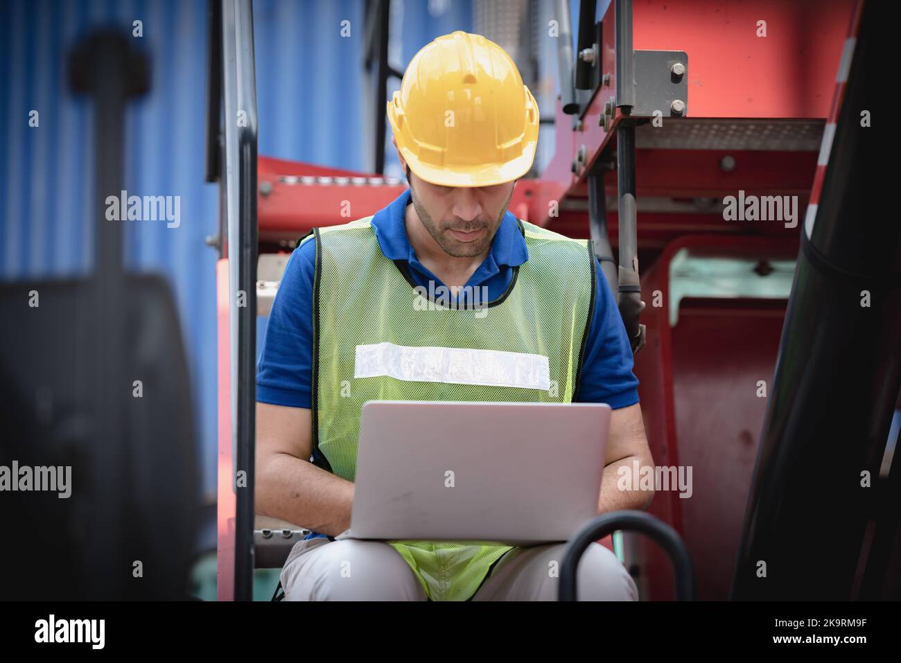 Export Import Computer Young man working with computer at logistic import and export terminal ...