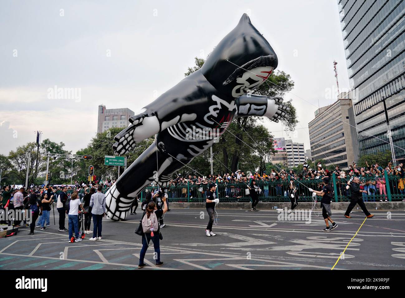 Mexico City, Mexico. 29th Oct, 2022. A giant skeleton hot air float is guided down Paseo de la Reforma street during the Grand Parade of the Dead to celebrate Dia de los Muertos holiday, October 29, 2022 in Mexico City, Mexico. Credit: Richard Ellis/Richard Ellis/Alamy Live News Stock Photo