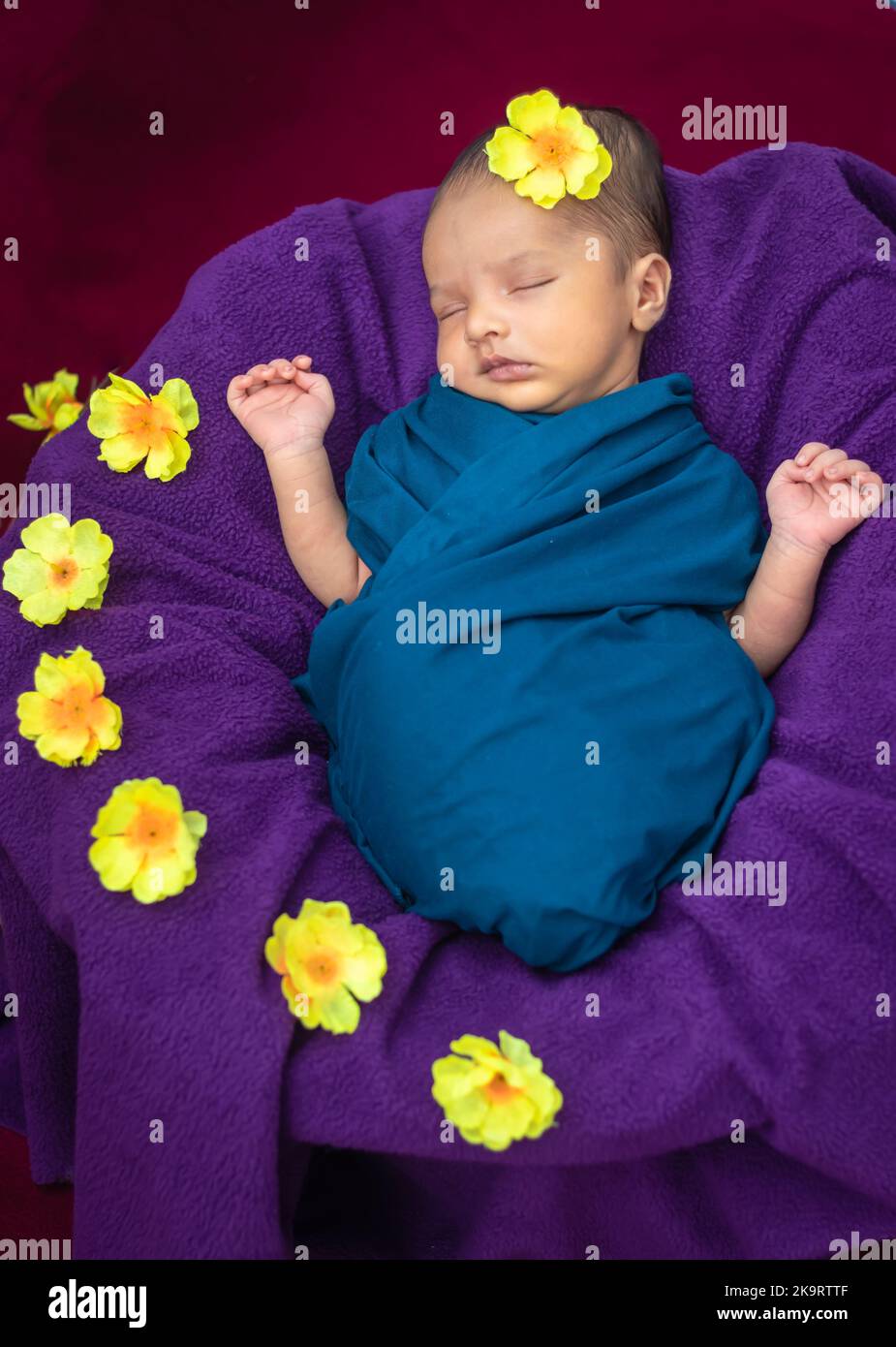 cute newborn baby sleeping in baby wrap with flowers in unique style from top angle shot Stock Photo Alamy