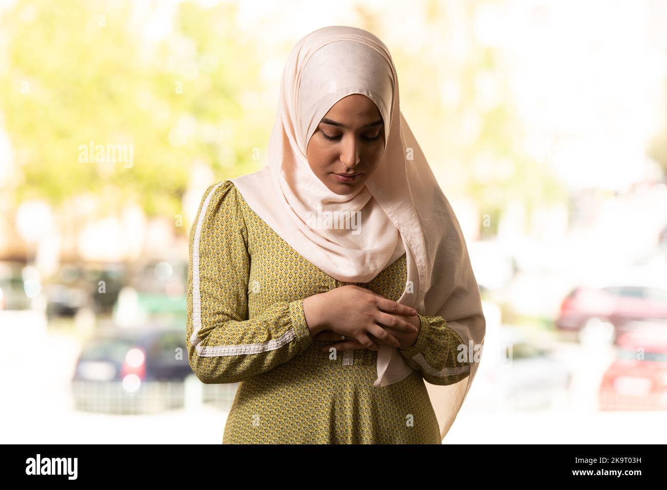 Muslim Woman in Beige Hijab and Traditional Clothes Praying for Allah
