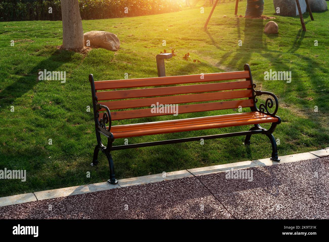 Wooden bench in the city park Stock Photo - Alamy