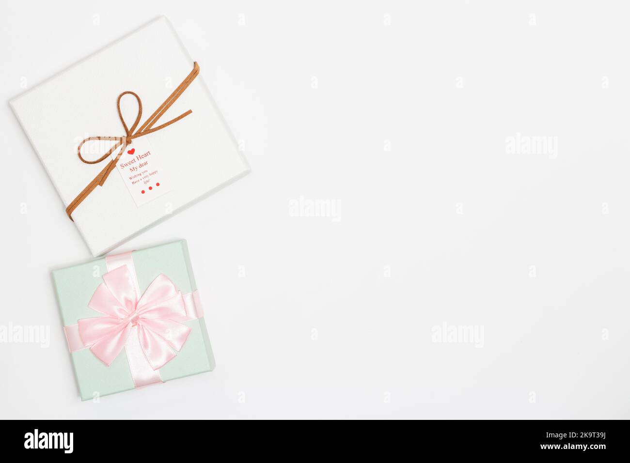Pastel Ribbon Box Christmas concept, Green pastel gift box wraps pink satin ribbon and ...