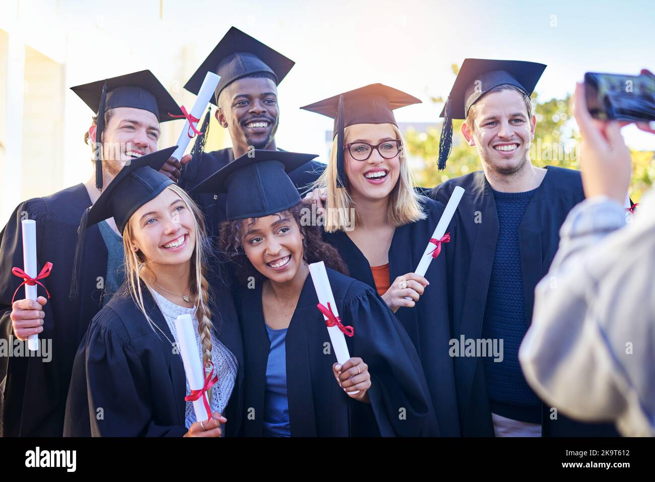 Getting a group photo of everyone. students on graduation day from university. Stock Photo