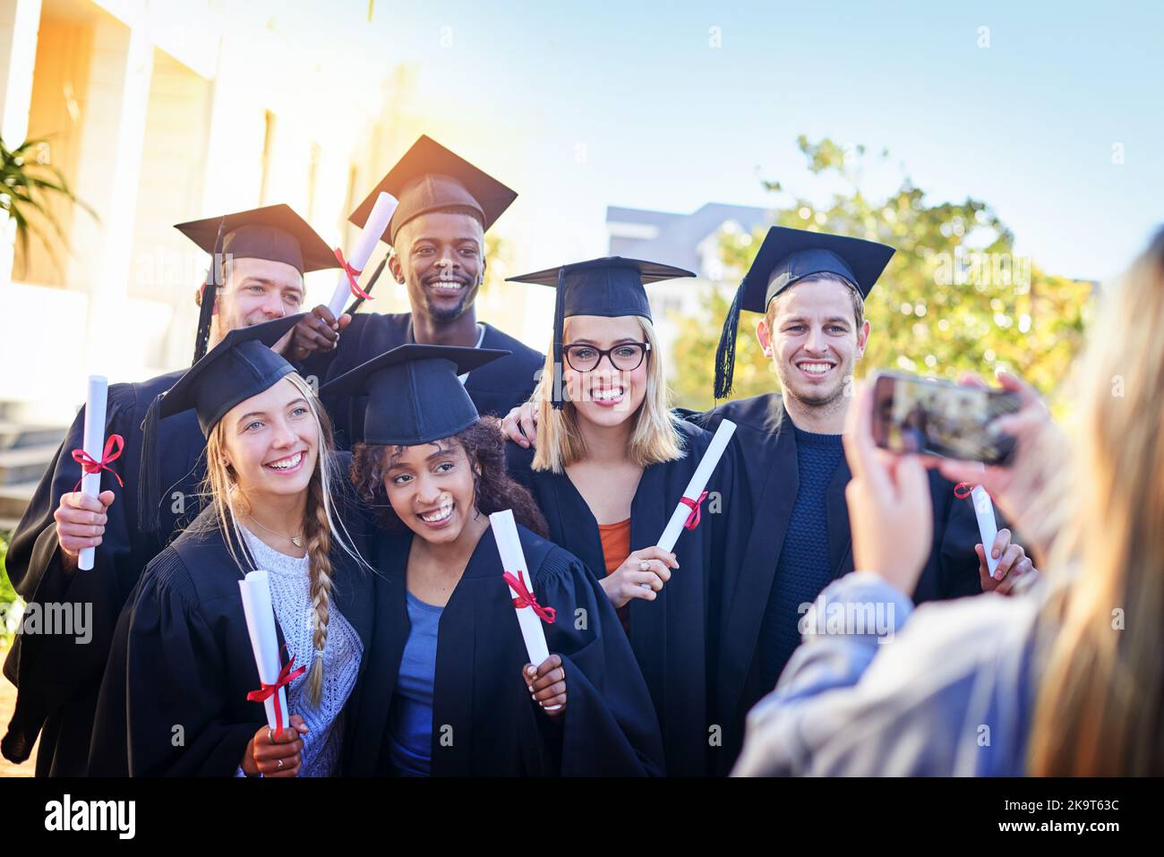 Everyone is a bit snap-happy. students on graduation day from university. Stock Photo