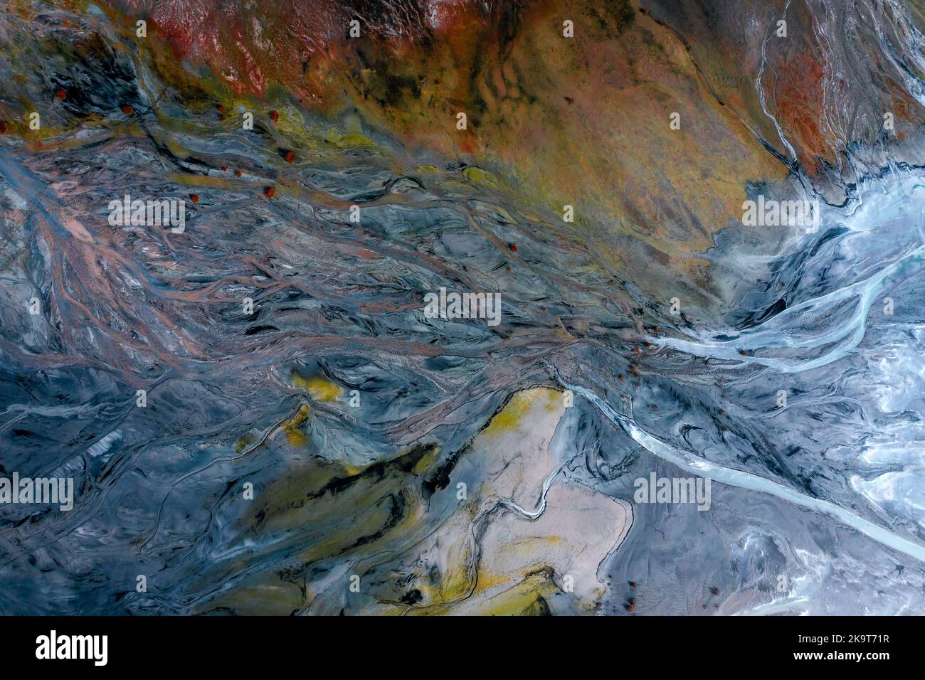 Colorful aerial ground texture with errosion and polution. red mud storage. Abstract paint background. Aerial volcanic river texture Stock Photo