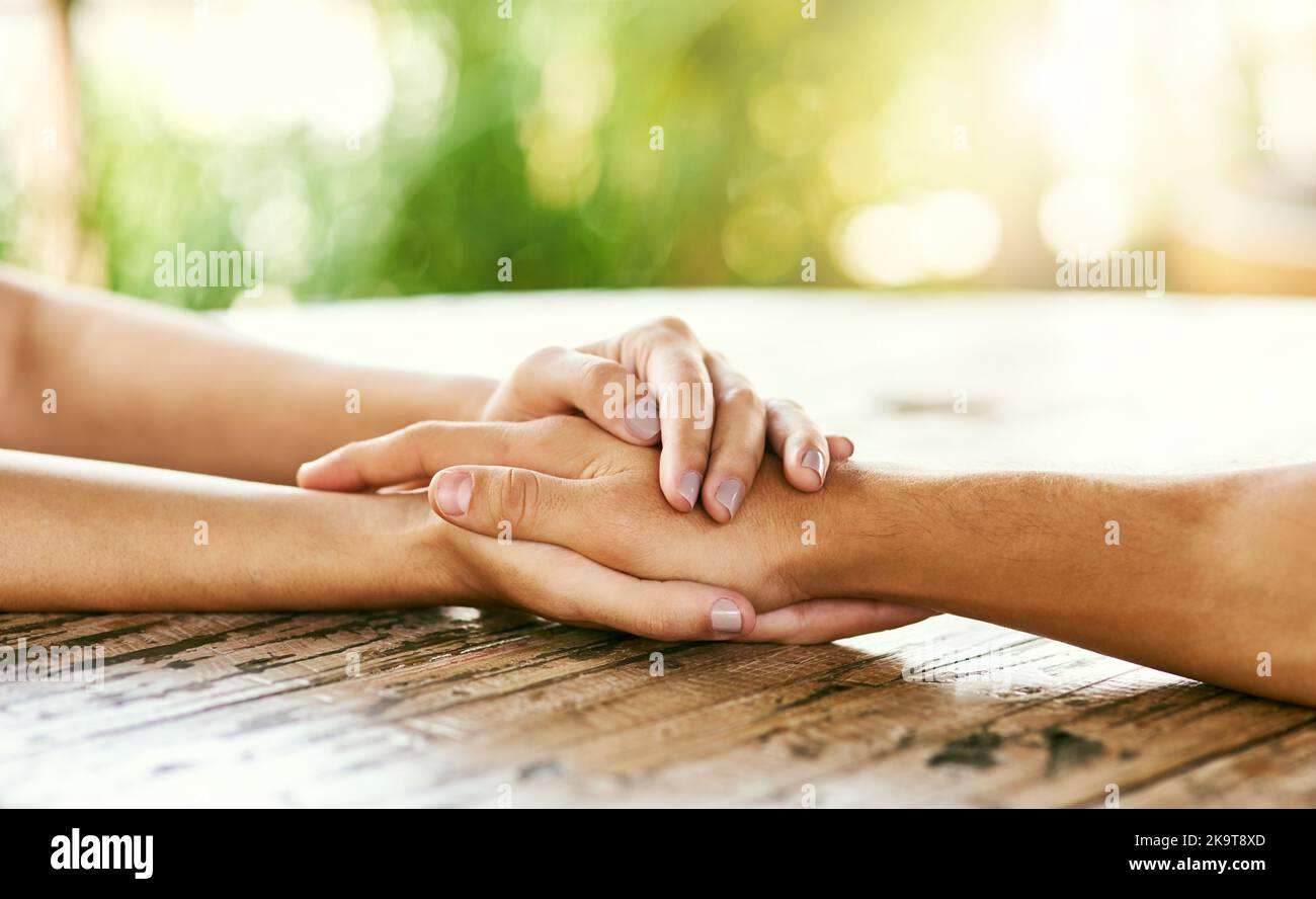 Small gestures can mean the most. Closeup shot of a man and woman holding hands in comfort on a