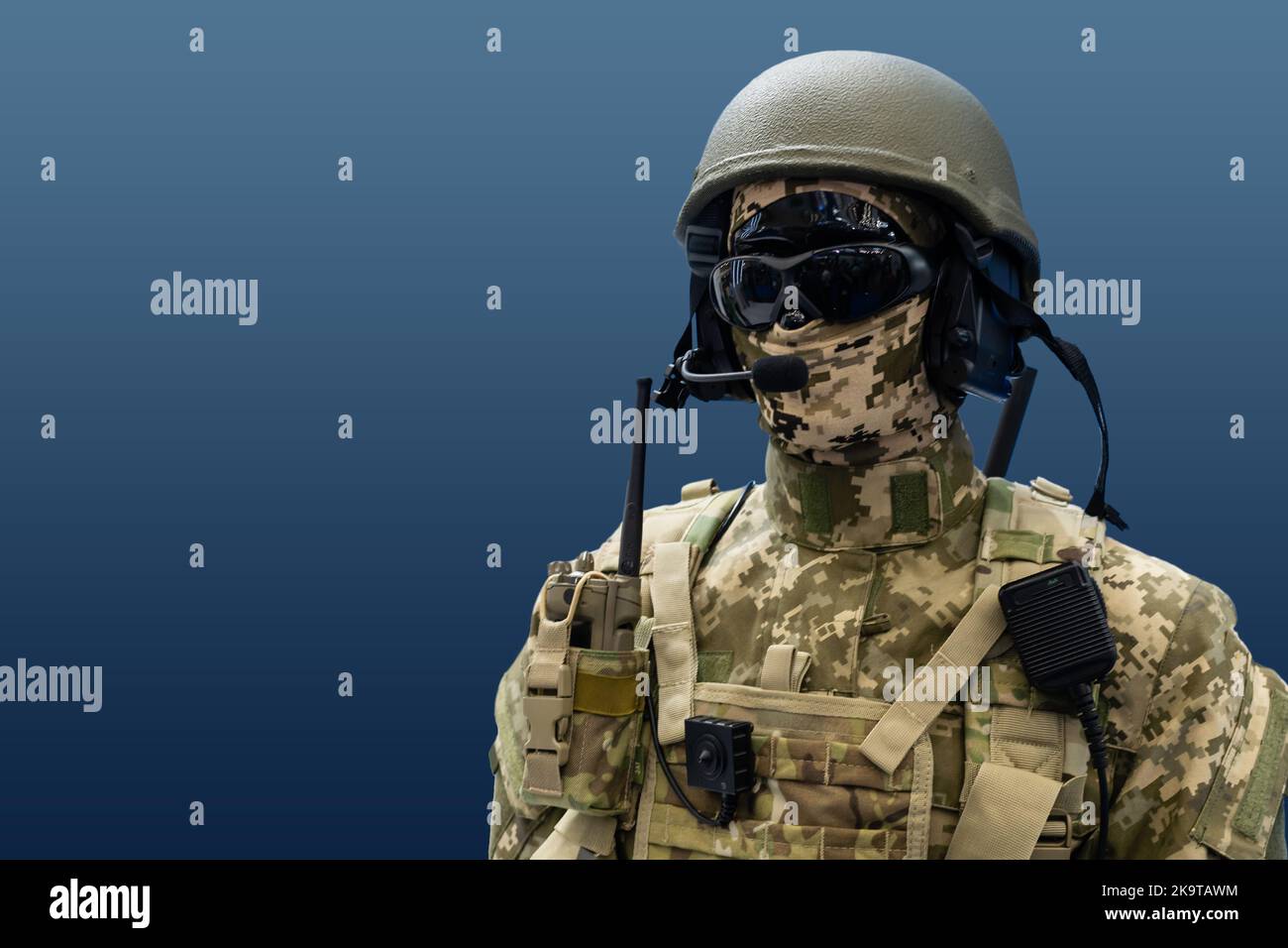 Elite member of Army rangers in helmet and dark glasses. Studio shot, dark black background, looking at camera, dark contrast Stock Photo