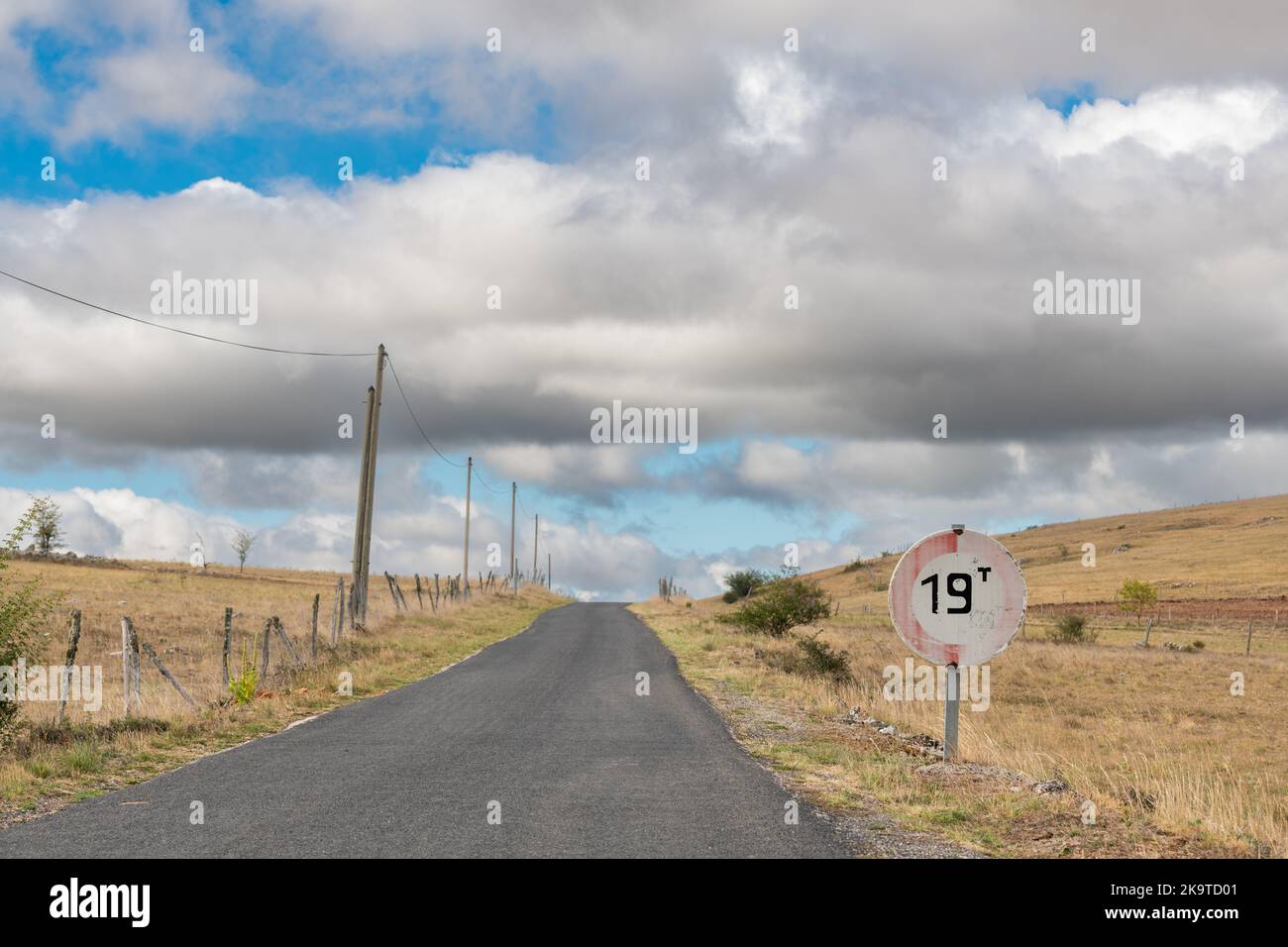Desolate road in the countryside on a sunny summer day. Cevennes, France. Stock Photo