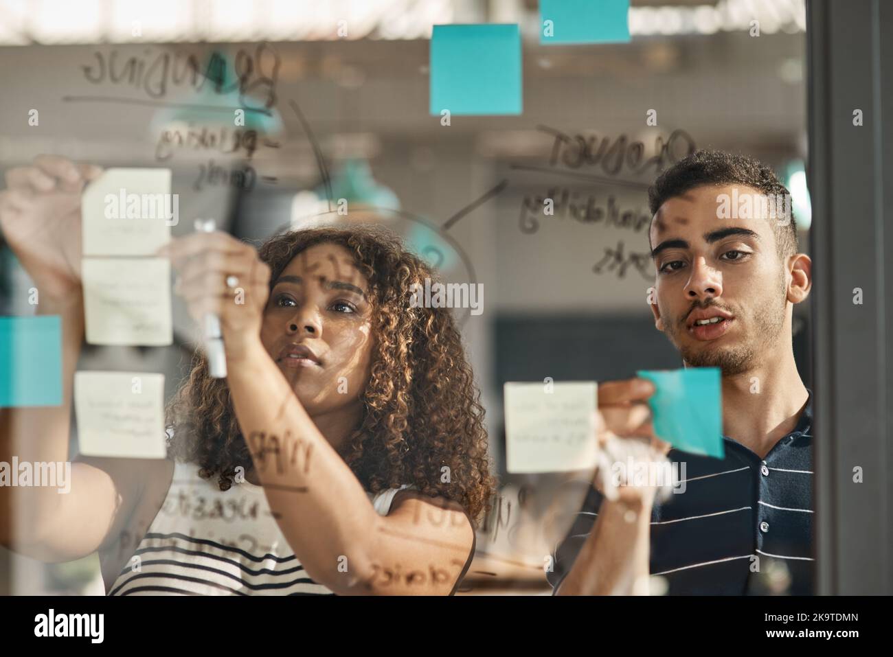 The best ideas blossom together. two young designers brainstorming with