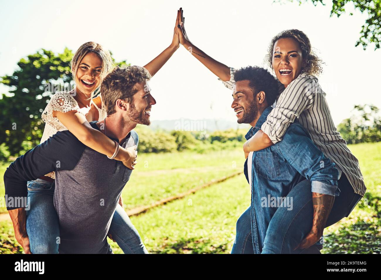 Bring on the fun times. Portrait of two happy young couples out on a double date. Stock Photo