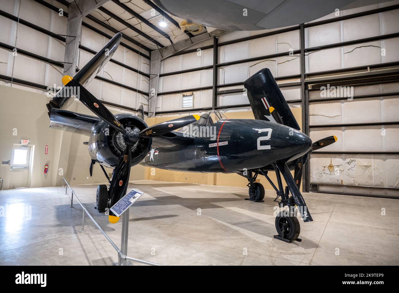 A twin prop aircraft with folded wings on display at the Pima Air and