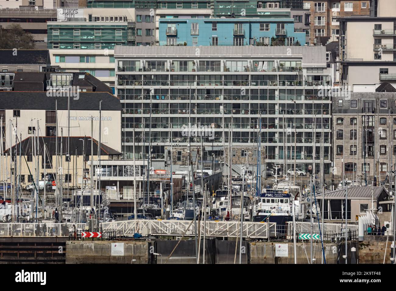 Boats and housing at Sutton Harbour Plymouth. A telephoto lens gives a very graphic image Stock Photo