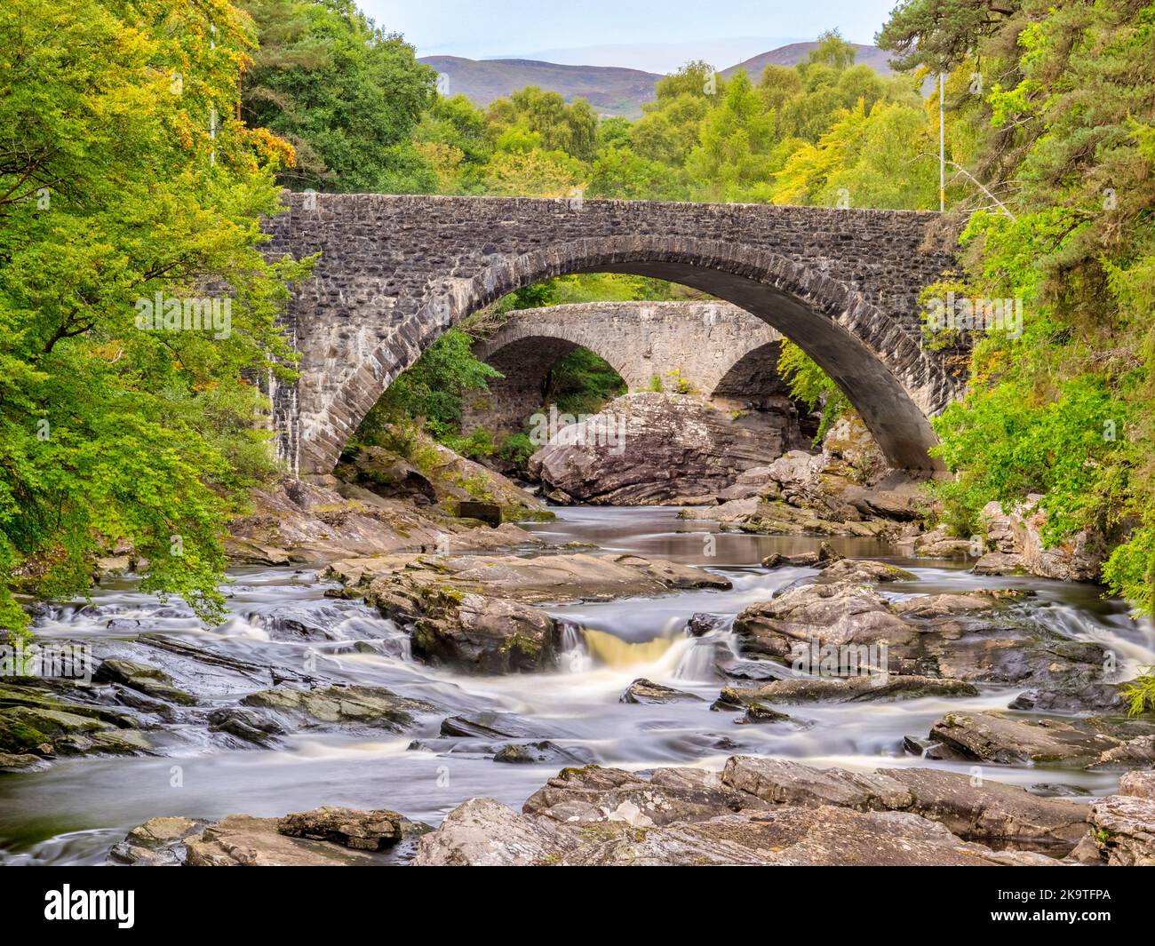 The River Moriston at Invermoriston on the shores of Loch Ness, with the old and new road bridges. Stock Photo