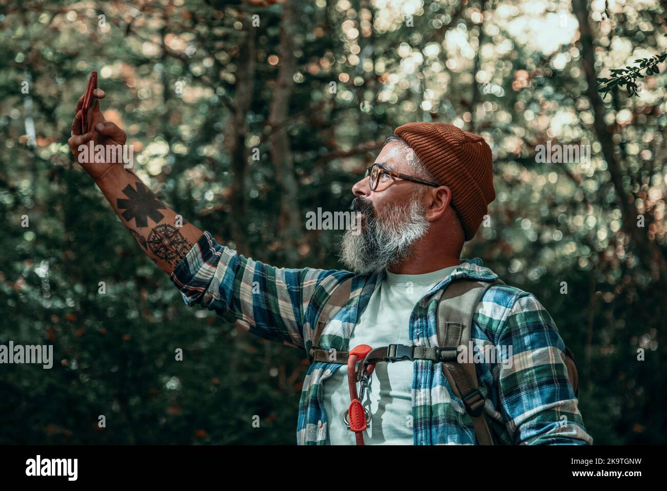 A Man Taking Selfie While Walking Through The Forest In Autumn Stock Photo