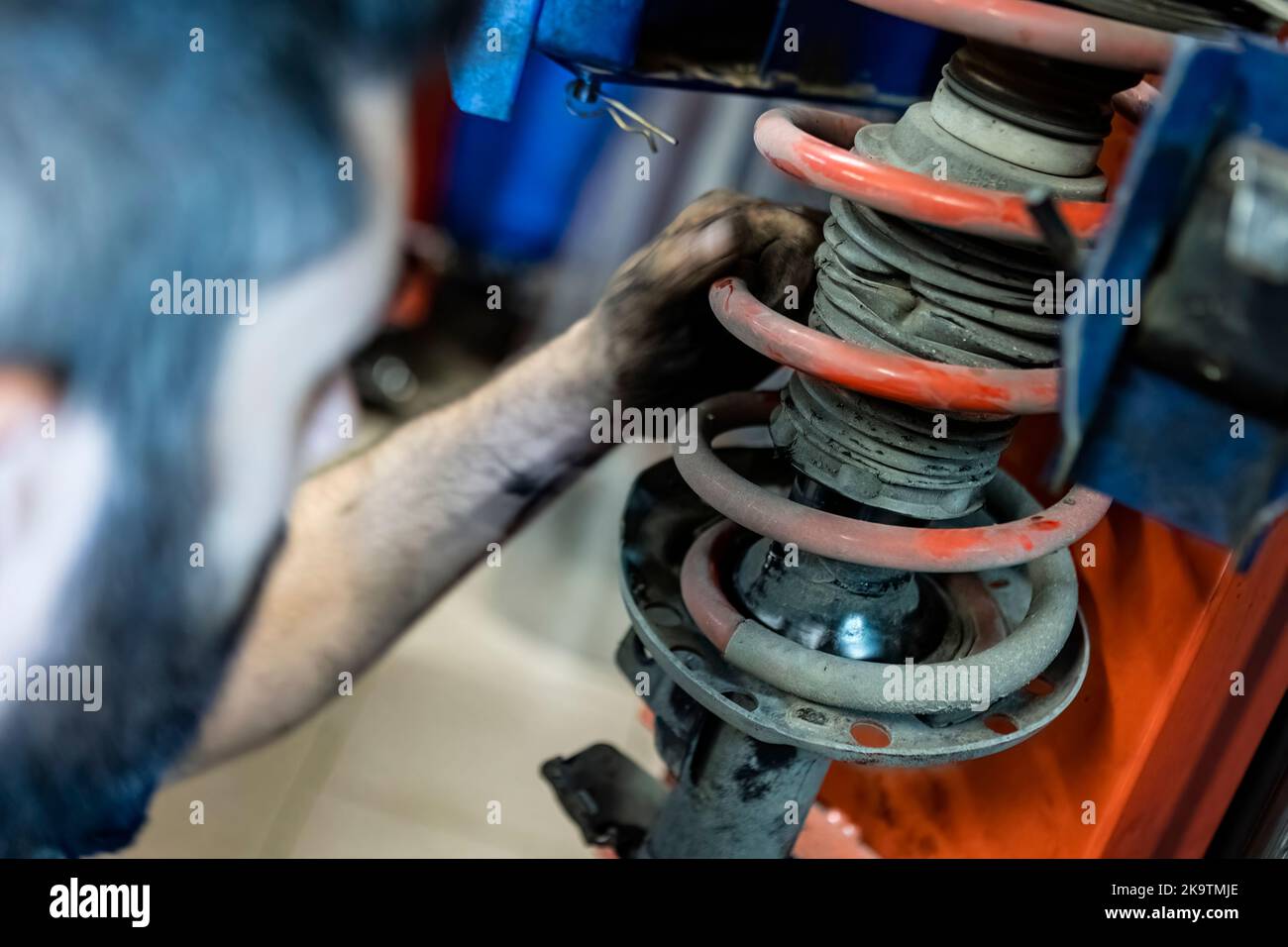 Mechanic hands detail during a maintenance of car suspension Stock