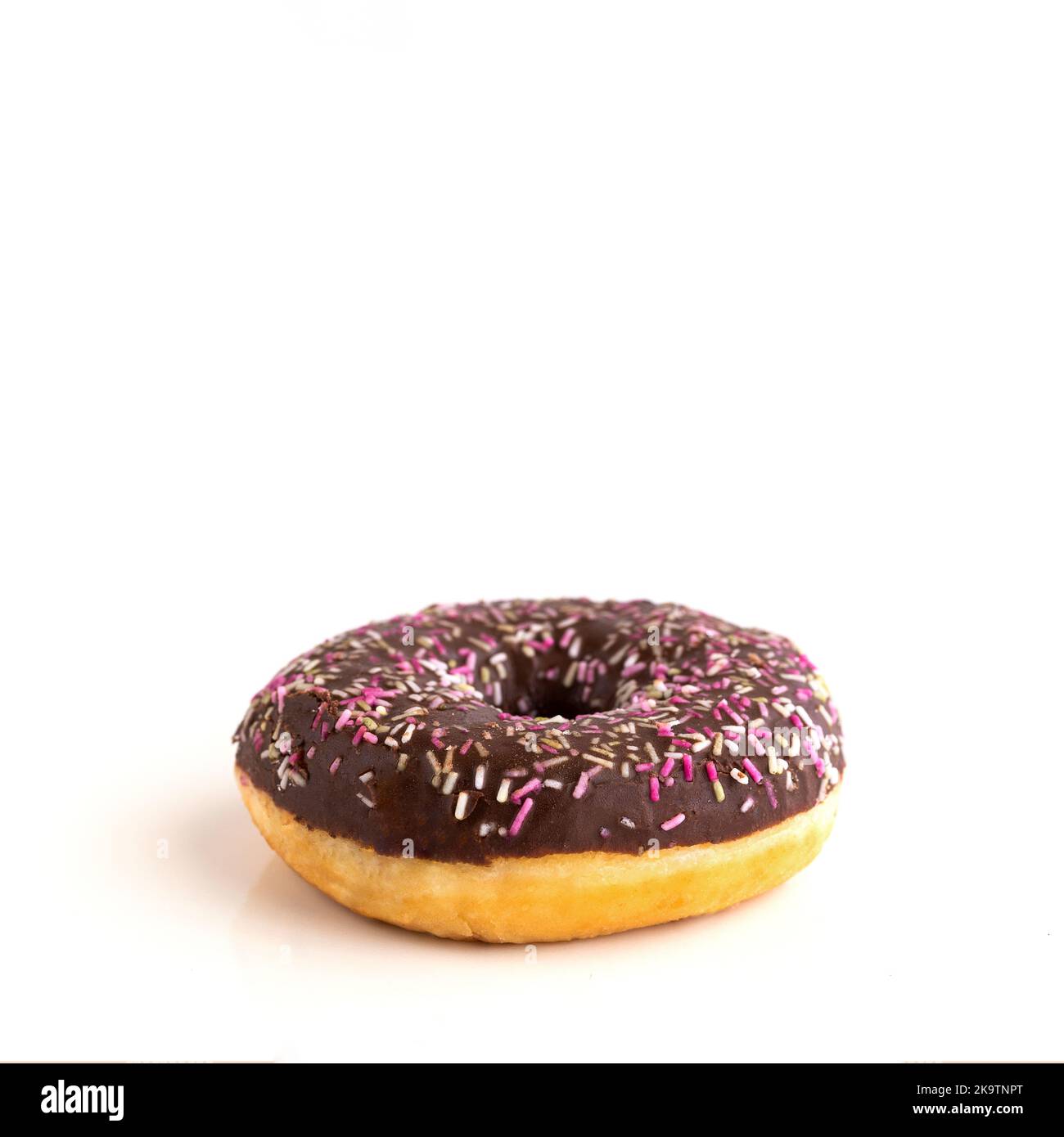Close up of donut with sprinkle on white isolated background. Copy space Stock Photo