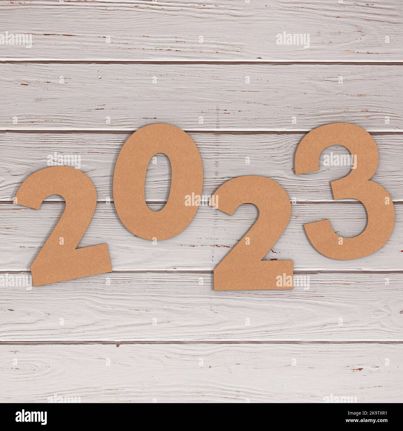 Cardstock Numbers 2023 Happy New Year Sign over wooden table background