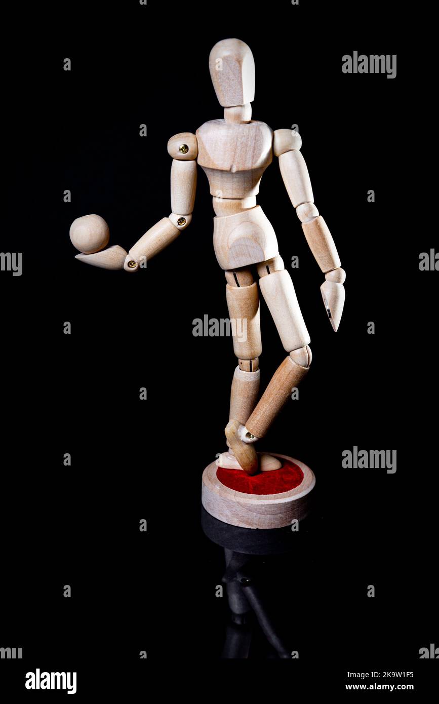Image of falling wooden manikin on black background, wooden manikin