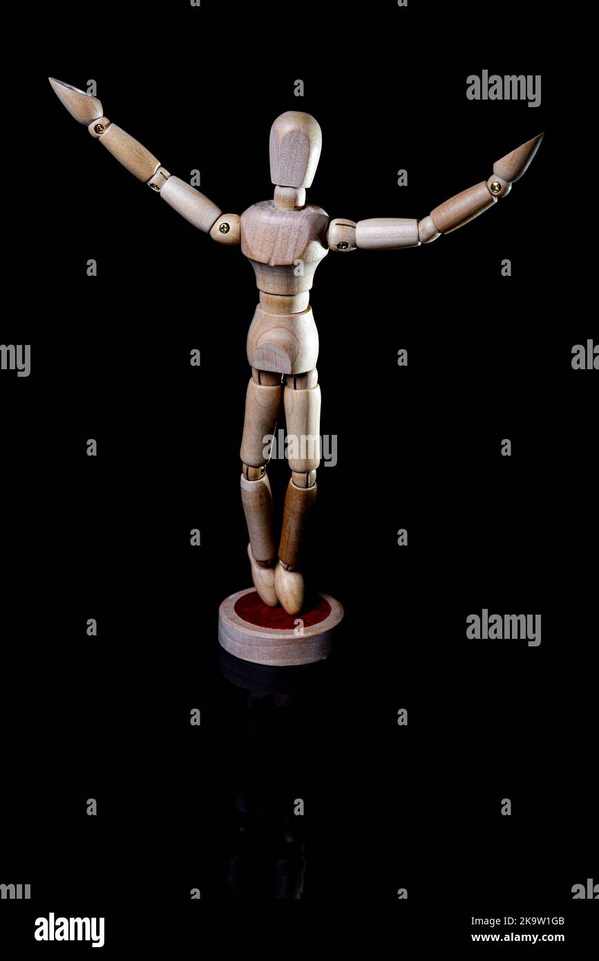 Image of falling wooden manikin on black background, wooden manikin poses different posing Stock Photo