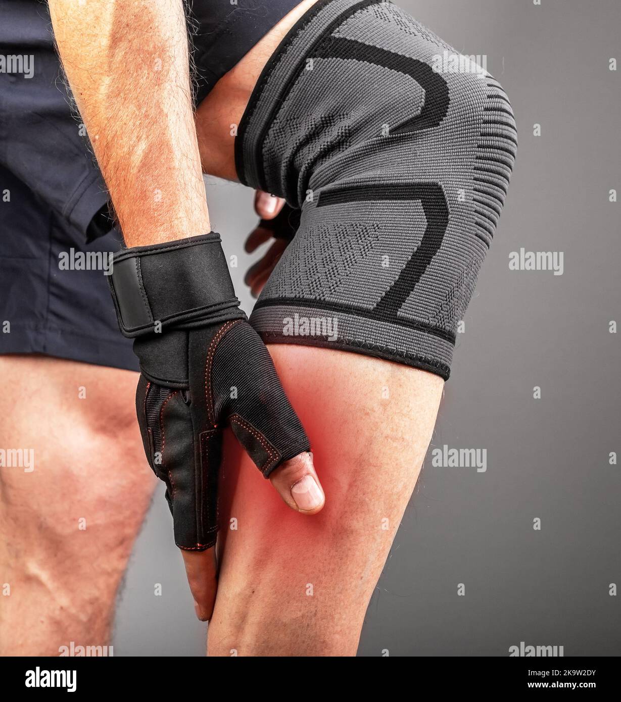 Calf muscle pain, ache, leg cramp, shin spasm of athlete in gym. High quality photo Stock Photo