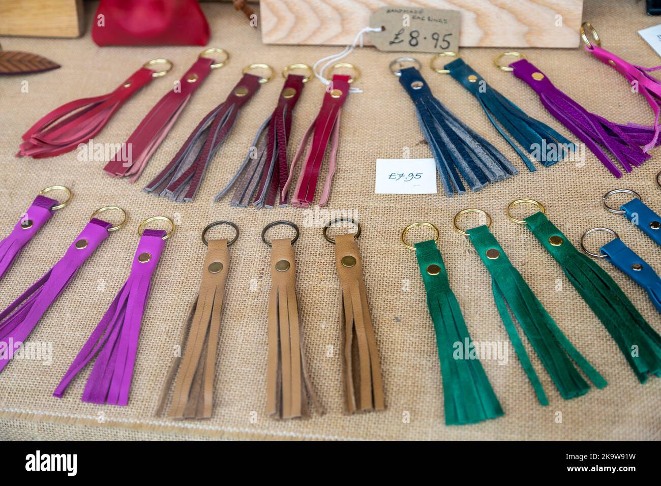 Leatherwork tassel key rings on display in shop window, Devizes, Wiltshire, England, UK Stock Photo