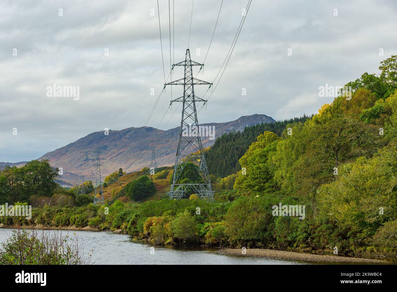 Electricity pylons running beside the River Conon in Strathconon, a remote glen in the Scottish Highlands, providing power to residents and businesses Stock Photo