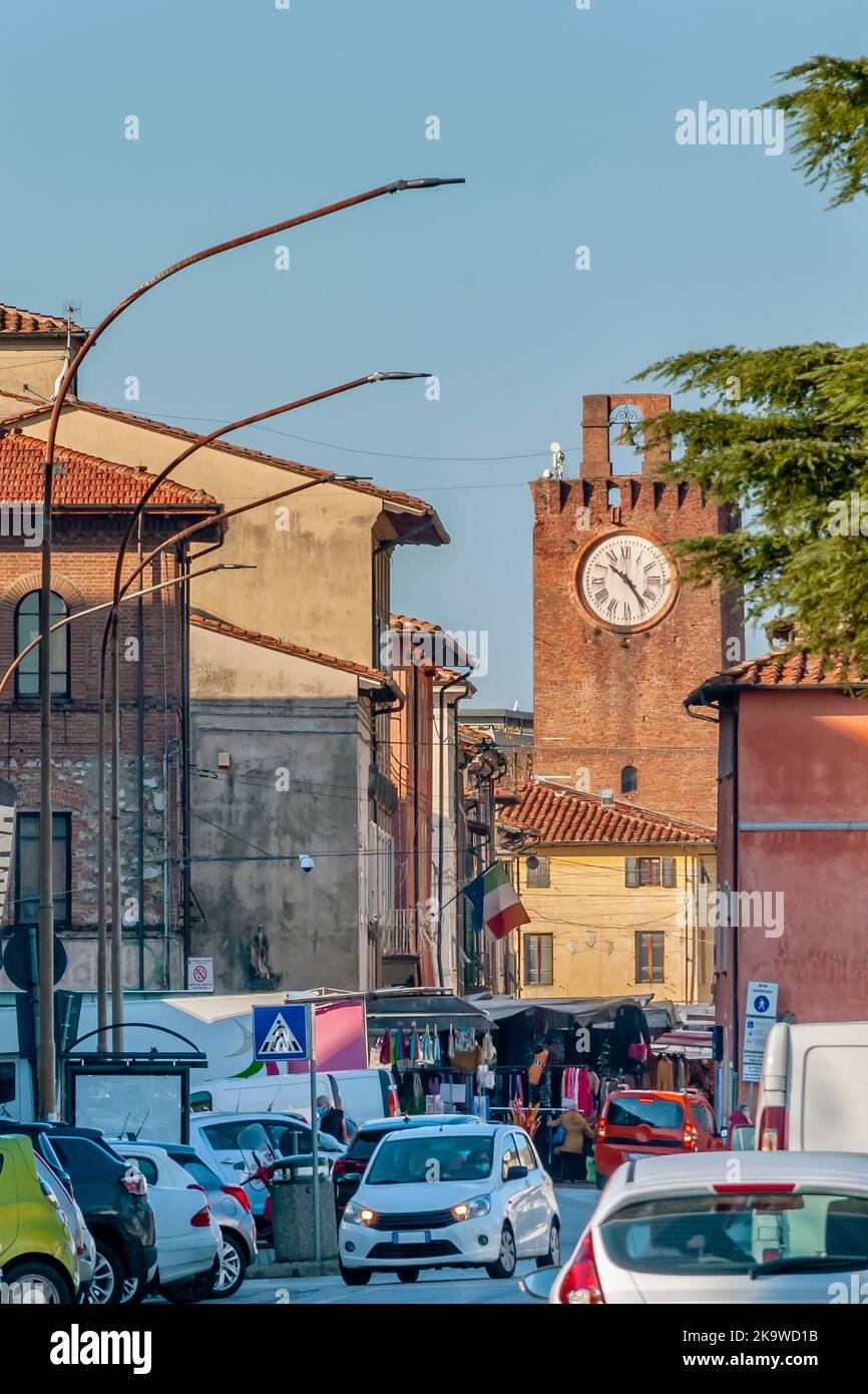 The weekly market on Thursday morning in the historic center of Cascina, Pisa, Italy, with the ancient clock tower in the background Stock Photo