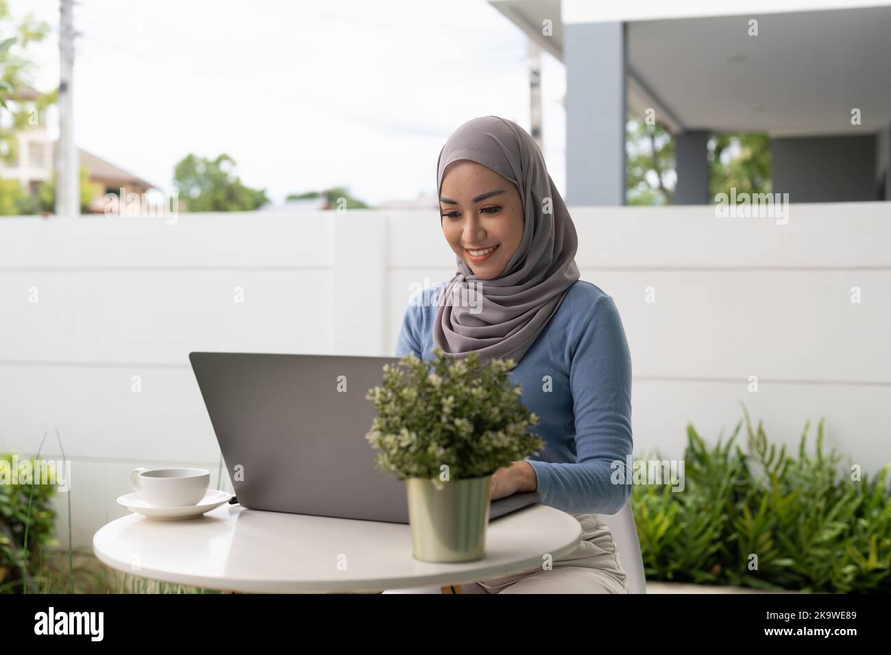 Portrait of Muslim asian woman in hijab using laptop at home Stock ...