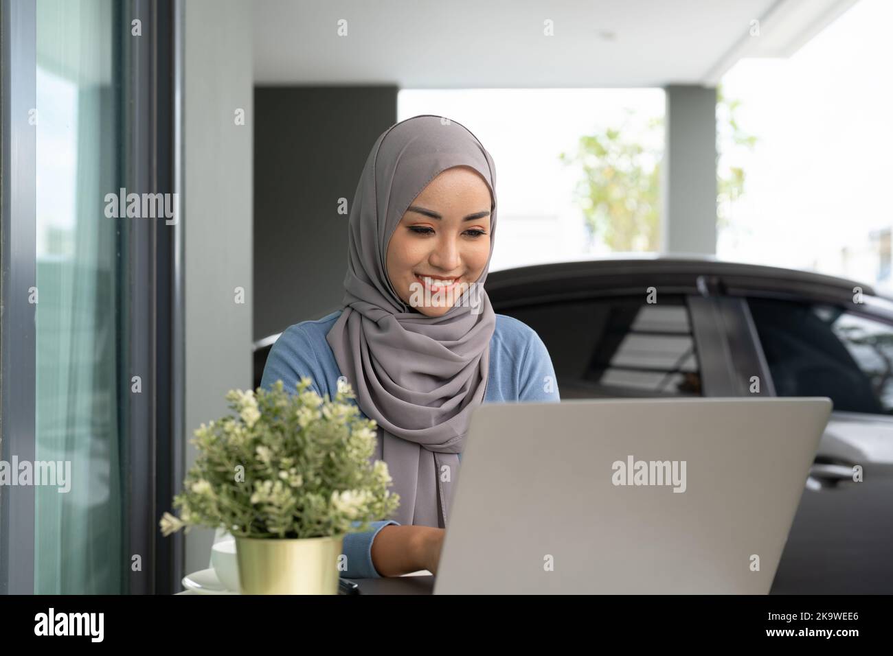Portrait of Muslim asian woman in hijab using laptop at home Stock ...