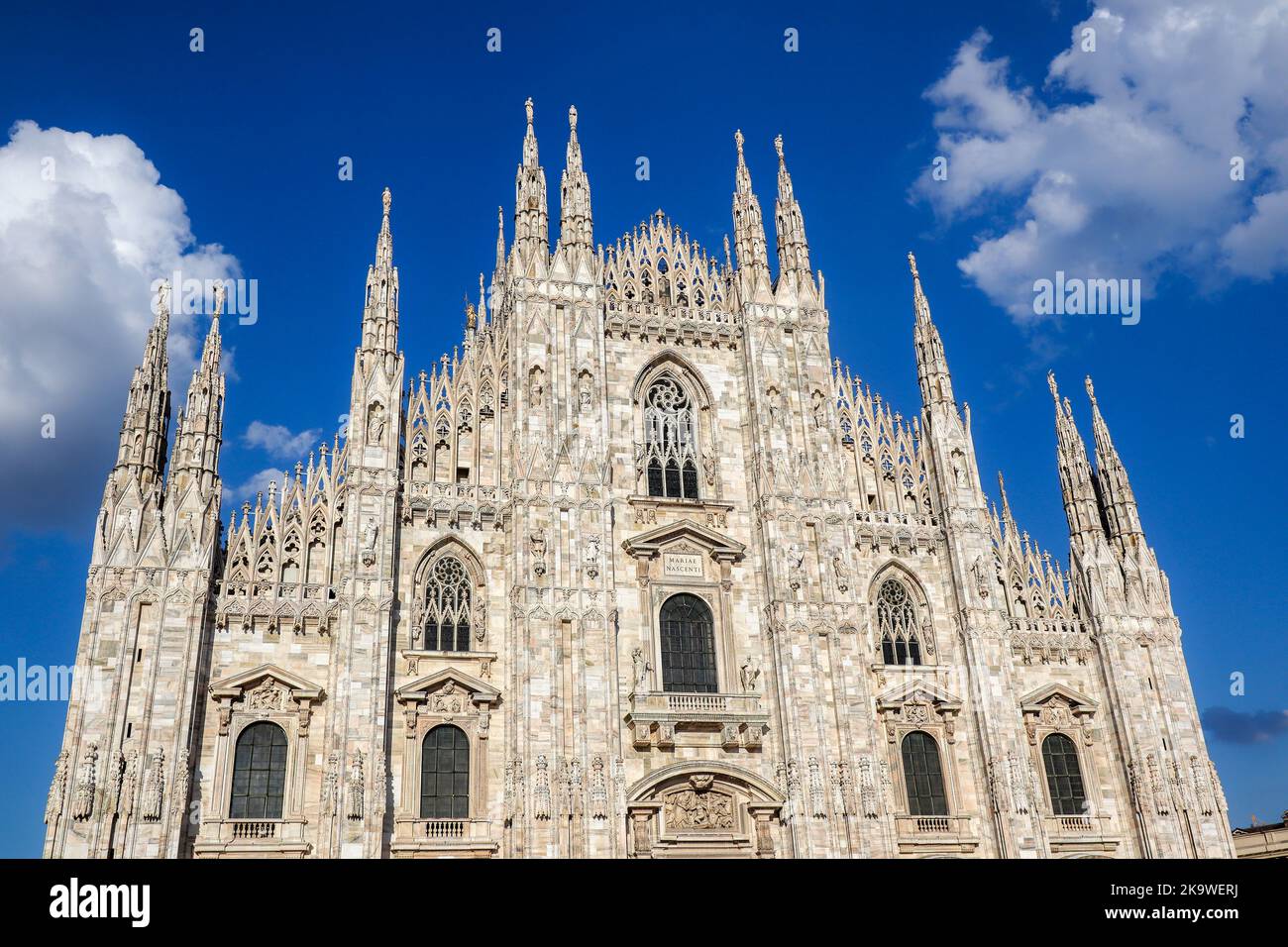 Cathedral Duomo di Milano in Italy. Beautiful Architectural Landmark in Northern Italy. Historic Building with Blue Sky with Clouds. Stock Photo