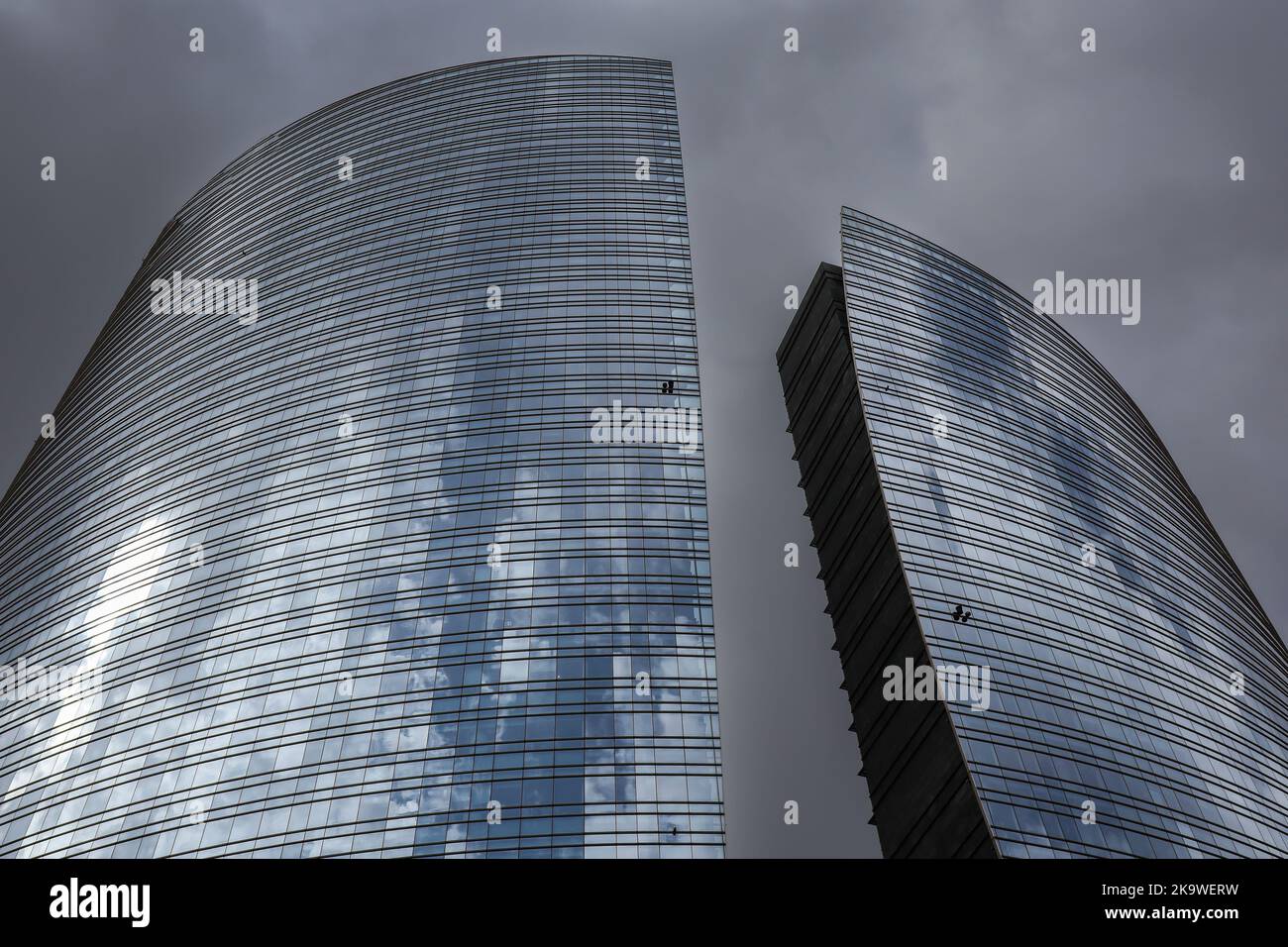Milan, Italy - June 26, 2022: Below Architecture of Unicredit Tower in Porta Nuova. Modern Glass Architecture in Lombardy with Cloudy Sky. Stock Photo