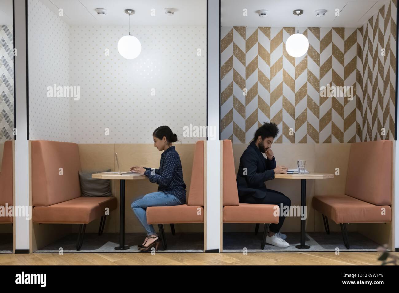 Two Indian freelancer working in coworking use modern technologies Stock Photo