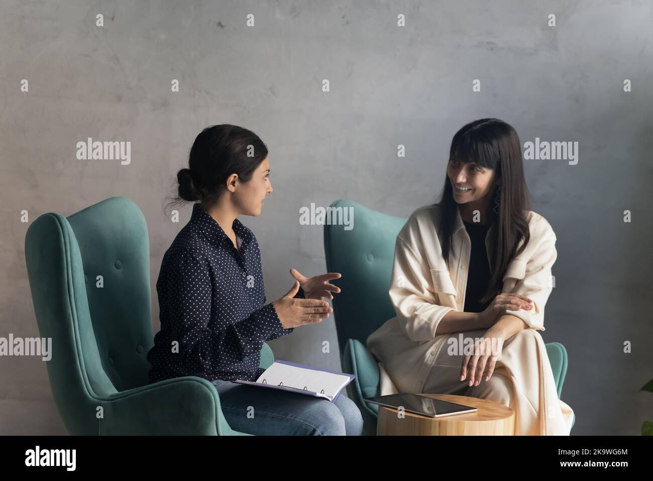 Negotiations of two multi ethnic businesswomen in modern office Stock Photo
