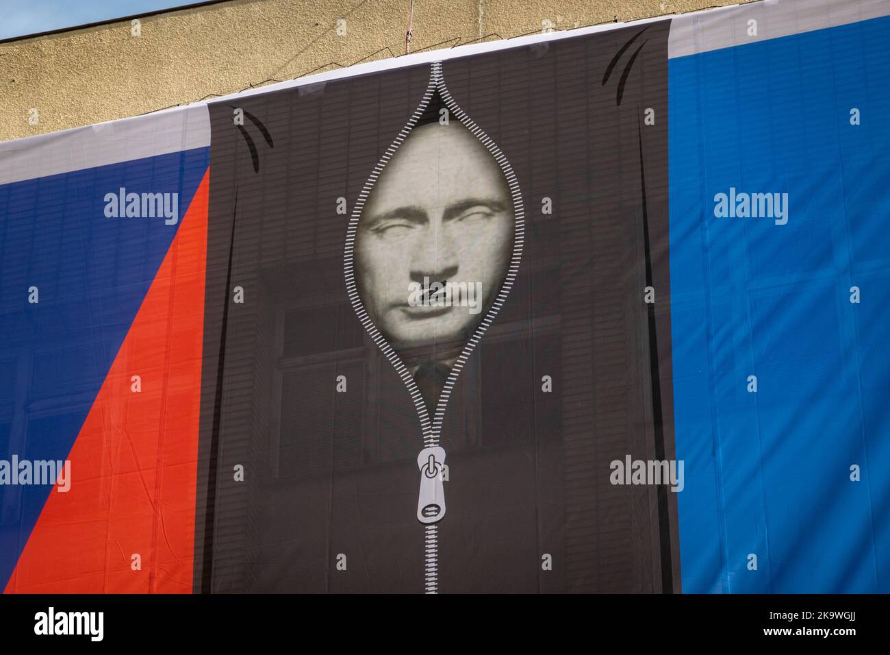 Czech Interior Ministry building with banner. Russian president, Vladimir Putin, in a black body bag between flags of the Czech Republic and Ukraine. Stock Photo