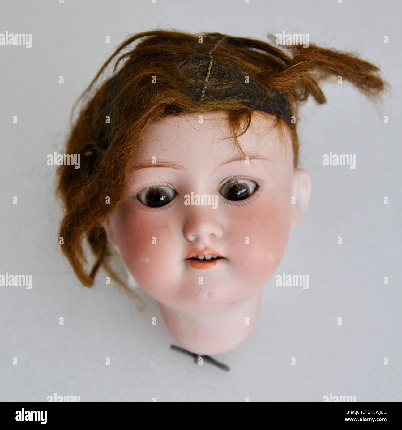 Scary vintage antique broken dolls head Stock Photo