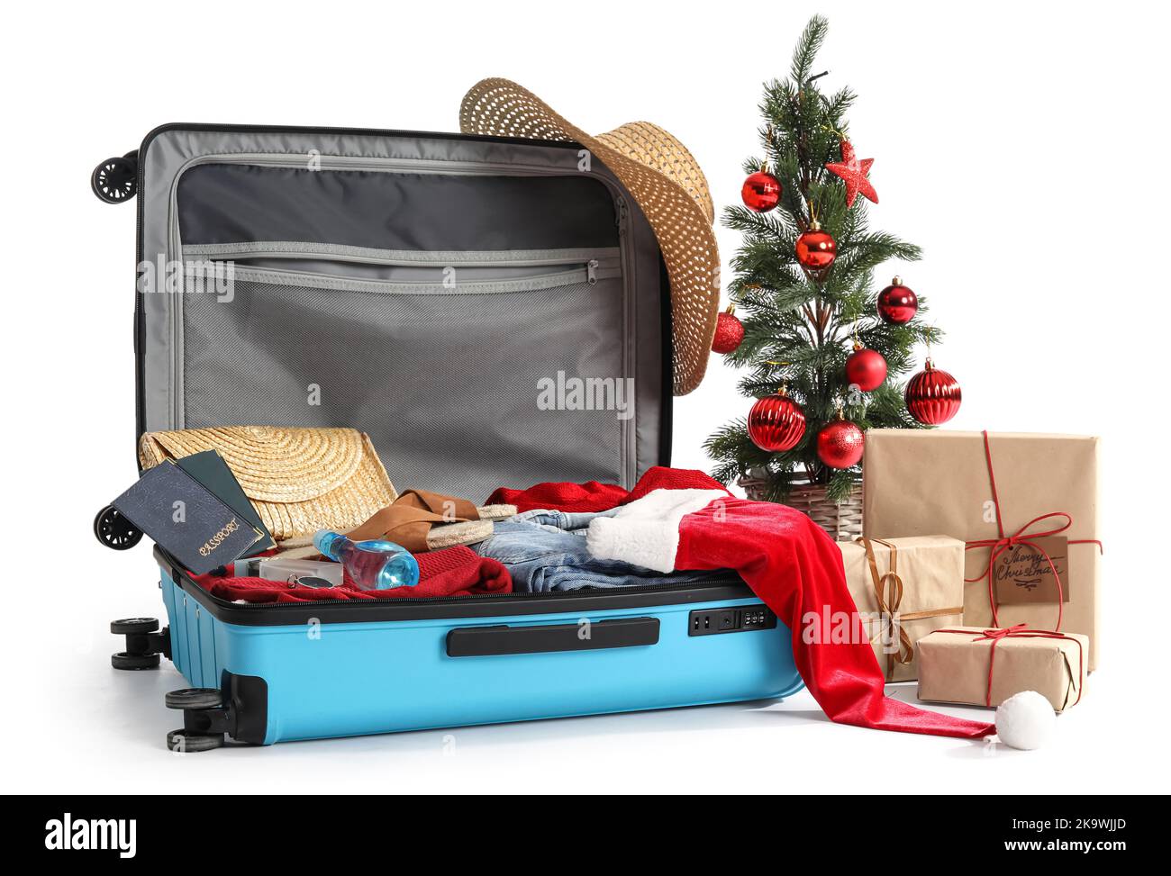 Suitcase with Santa hat, Christmas tree, gifts and travel accessories