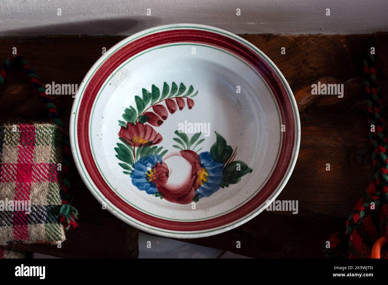 A vintage traditional handmade pottery plate from Romania displayed on